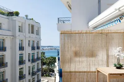 a view of the ocean from the balcony of a building at Martinez area Superb 1 bed w XXL terrace in Cannes