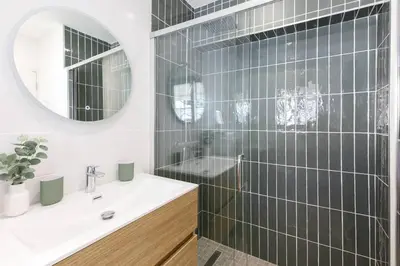 a bathroom with a sink and a shower with a mirror at Martinez area Superb 1 bed w XXL terrace in Cannes