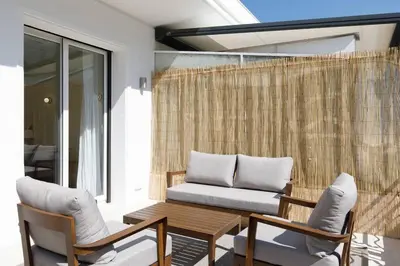 a patio with a bench and a table and chairs at Martinez area Superb 1 bed w XXL terrace in Cannes