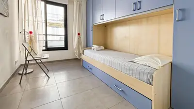 a bedroom with a bed and a chair in it at Modern 2 Bd Next To Rue Dantibes in Cannes