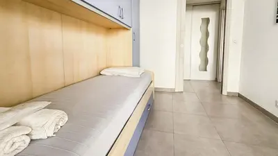 a bed in a room with two towels on it at Modern 2 Bd Next To Rue Dantibes in Cannes
