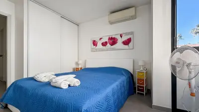 a bedroom with a blue bed with towels on it at Modern 2 Bd Next To Rue Dantibes in Cannes