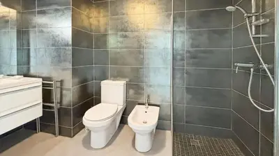 a bathroom with a toilet and a shower at Modern 2 Bd Next To Rue Dantibes in Cannes