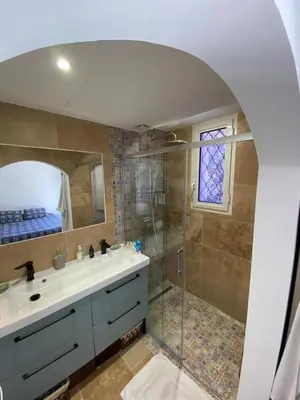 a bathroom with a shower and a sink and a mirror at Résidence Cannes in Cannes