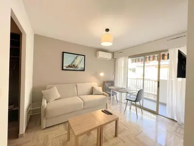 a living room with a couch and a table at LM Studio by Welcome to Cannes in Cannes