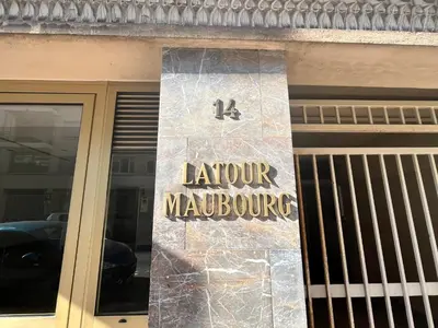 a sign on the front of a revolving door at LM Studio by Welcome to Cannes in Cannes