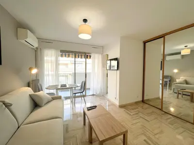 a living room with a couch and a table at LM Studio by Welcome to Cannes in Cannes