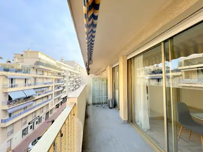a balcony of a building with windows and a table and chairs at LM Studio by Welcome to Cannes in Cannes