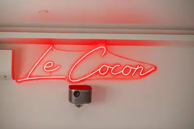 a close up of a cocacola sign on a wall at LE COCON- Jacuzzi & Sauna privés By SweetDreams in Le Cannet