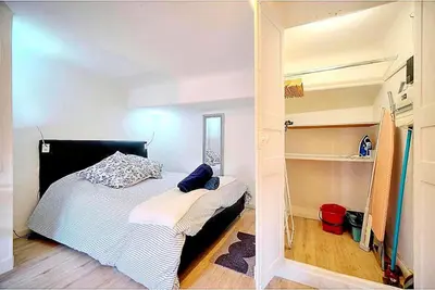 a small bedroom with a bed and a closet at Palais des festivals et rue d'Antibes charme mansardes in Cannes