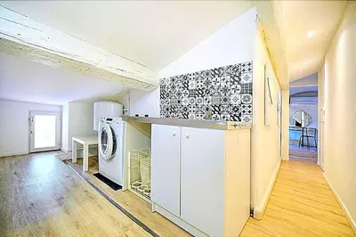 a kitchen with a washer and dryer in a room at Palais des festivals et rue d'Antibes charme mansardes in Cannes