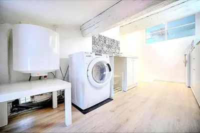 a laundry room with a washing machine in it at Palais des festivals et rue d'Antibes charme mansardes in Cannes