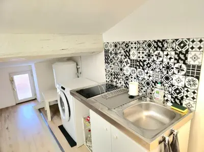 a small kitchen with a sink and a refrigerator at Palais des festivals et rue d'Antibes charme mansardes in Cannes