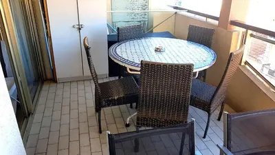 a table and chairs in a room with a window at Cannes Chataignier in Cannes