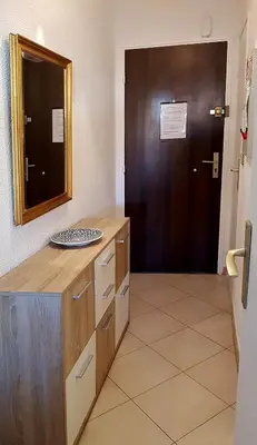 a bathroom with a counter with a mirror and a door at Cannes Chataignier in Cannes