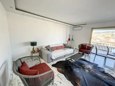 a living room with a couch and a table at SUQ3 - Très beau 2 pièces avec terrasse in Cannes