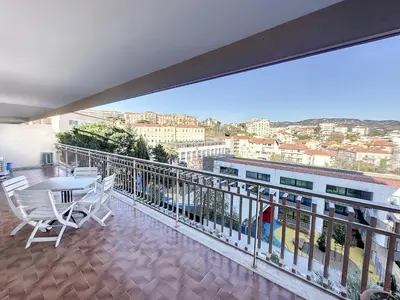a balcony with a table and chairs on a building at SUQ3 - Très beau 2 pièces avec terrasse in Cannes