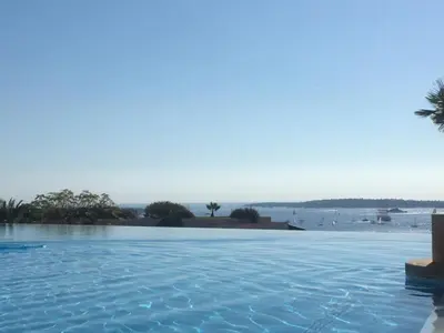 a swimming pool with a view of the water at CANNES VILLA FRANCIA in Cannes