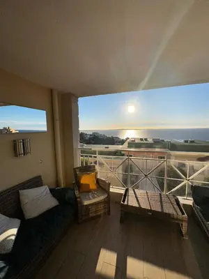 a balcony with a couch and a view of the ocean at CANNES VILLA FRANCIA in Cannes