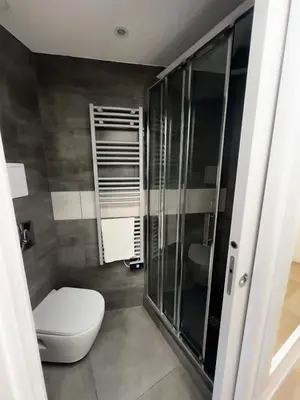 a bathroom with a toilet and a glass shower at CANNES VILLA FRANCIA in Cannes