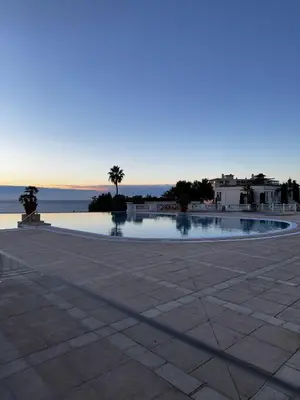 a swimming pool in a plaza with a view of the ocean at CANNES VILLA FRANCIA in Cannes