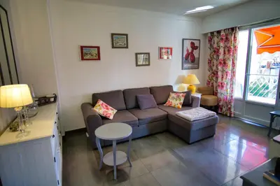 a living room with a couch and a table at Ref JUAS - Palmes d'Or Properties in Cannes