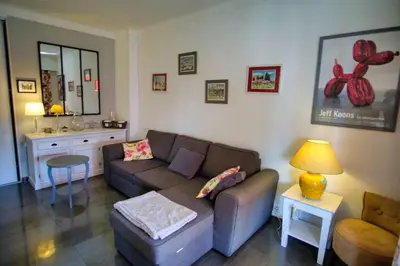 a living room with a couch and a table at Ref JUAS - Palmes d'Or Properties in Cannes