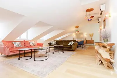 a living room with a red couch and tables at Candy in Cannes