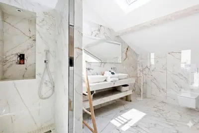 a bathroom with a shower and a sink and a mirror at Candy in Cannes
