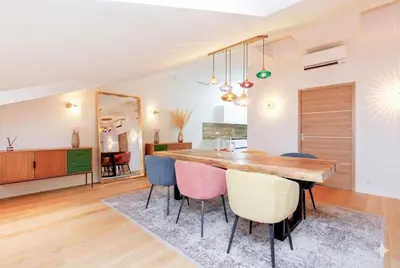 a kitchen and dining room with a wooden table and chairs at Candy in Cannes