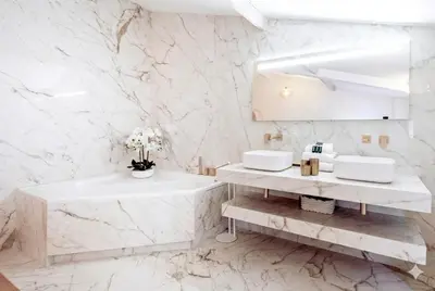 a white marble bathroom with two sinks and a mirror at Candy in Cannes