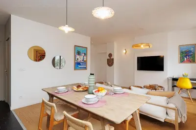 a living room with a table and a couch at Pegase in Cannes