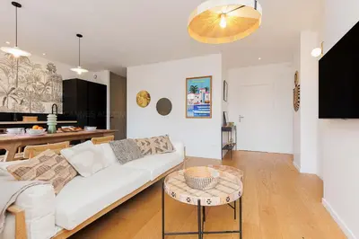 a living room with a white couch and a table at Pegase in Cannes