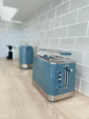 a blue toaster sitting on the floor in a room at Le Week Riviera - Spacieux 3 étoiles-Coeur de Cannes - Palais des Festivals- Terrasse - Clim- Garage in Cannes