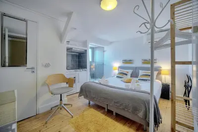 a bedroom with a bed and a desk and a chair at IMMOGROOM - 2 min from the Palais des Festival and the beaches - ac in Cannes