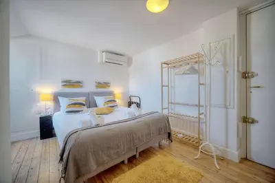 a bedroom with a large bed with white sheets and pillows at IMMOGROOM - 2 min from the Palais des Festival and the beaches - ac in Cannes