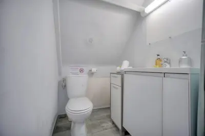 a white bathroom with a toilet and a sink at IMMOGROOM - 2 min from the Palais des Festival and the beaches - ac in Cannes