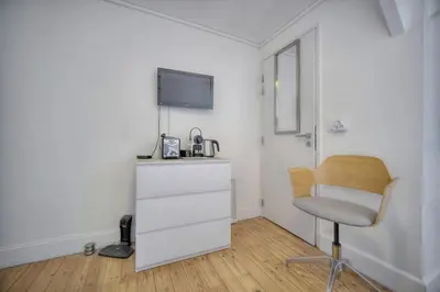 a room with a desk and a chair and a tv at IMMOGROOM - 2 min from the Palais des Festival and the beaches - ac in Cannes