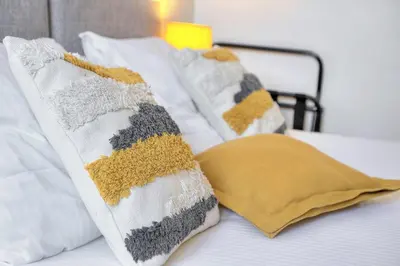 two pillows sitting on top of a bed at IMMOGROOM - 2 min from the Palais des Festival and the beaches - ac in Cannes