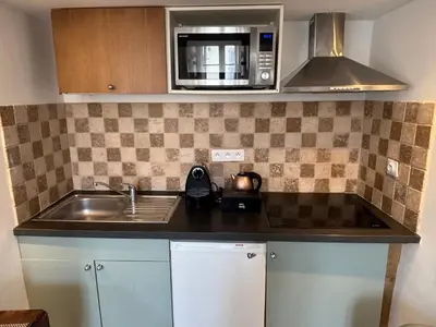 a kitchen with a sink and a microwave at Suquet 5 mins à pied du palais in Cannes