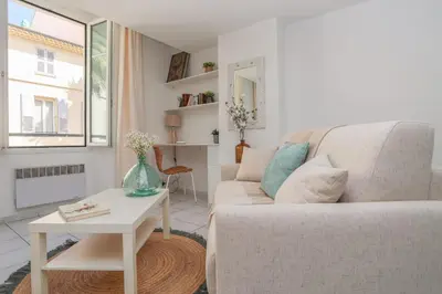 a living room with a couch and a table at IMMOGROOM - Best place in Cannes Center - AC - 5 min from beaches in Cannes