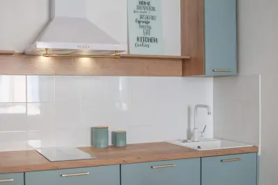 a kitchen with white cabinets and a sink at IMMOGROOM - Best place in Cannes Center - AC - 5 min from beaches in Cannes