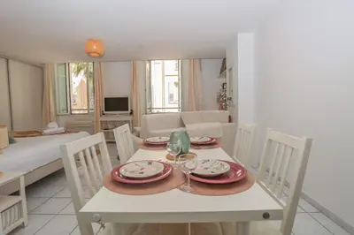 a table with plates and wine glasses on it at IMMOGROOM - Best place in Cannes Center - AC - 5 min from beaches in Cannes
