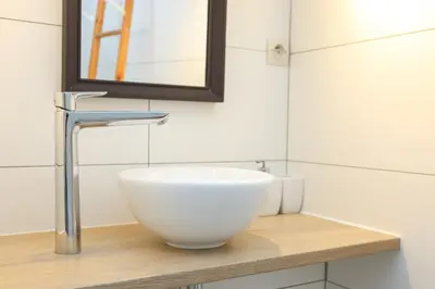 a bathroom with a bowl sink and a mirror at IMMOGROOM - Duplex with air conditioner - 5 min from the beach - Suquet in Cannes