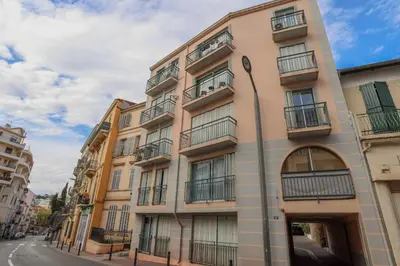 a tall building with balconies on a street at IMMOGROOM - Duplex with air conditioner - 5 min from the beach - Suquet in Cannes