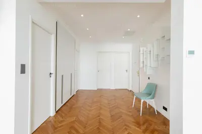 a room with white walls and a blue chair at Alba in Cannes