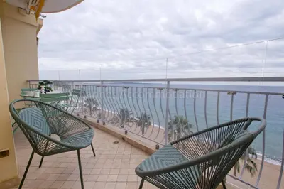 a balcony with chairs and a view of the water at Alba in Cannes