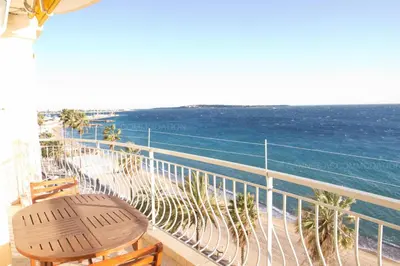 a balcony with a table and chairs and the ocean at Alba in Cannes