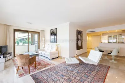 a living room with white furniture and a table at GRAY 4f1 in Cannes