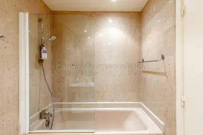 a bath tub in a bathroom with a shower at GRAY 4f1 in Cannes